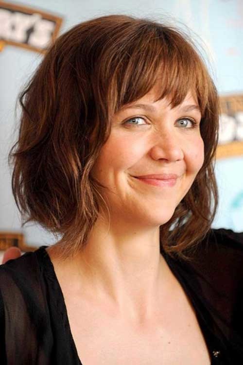 Maggie Gyllenhaal Wavy Hairdo with Bangs for Round Faces