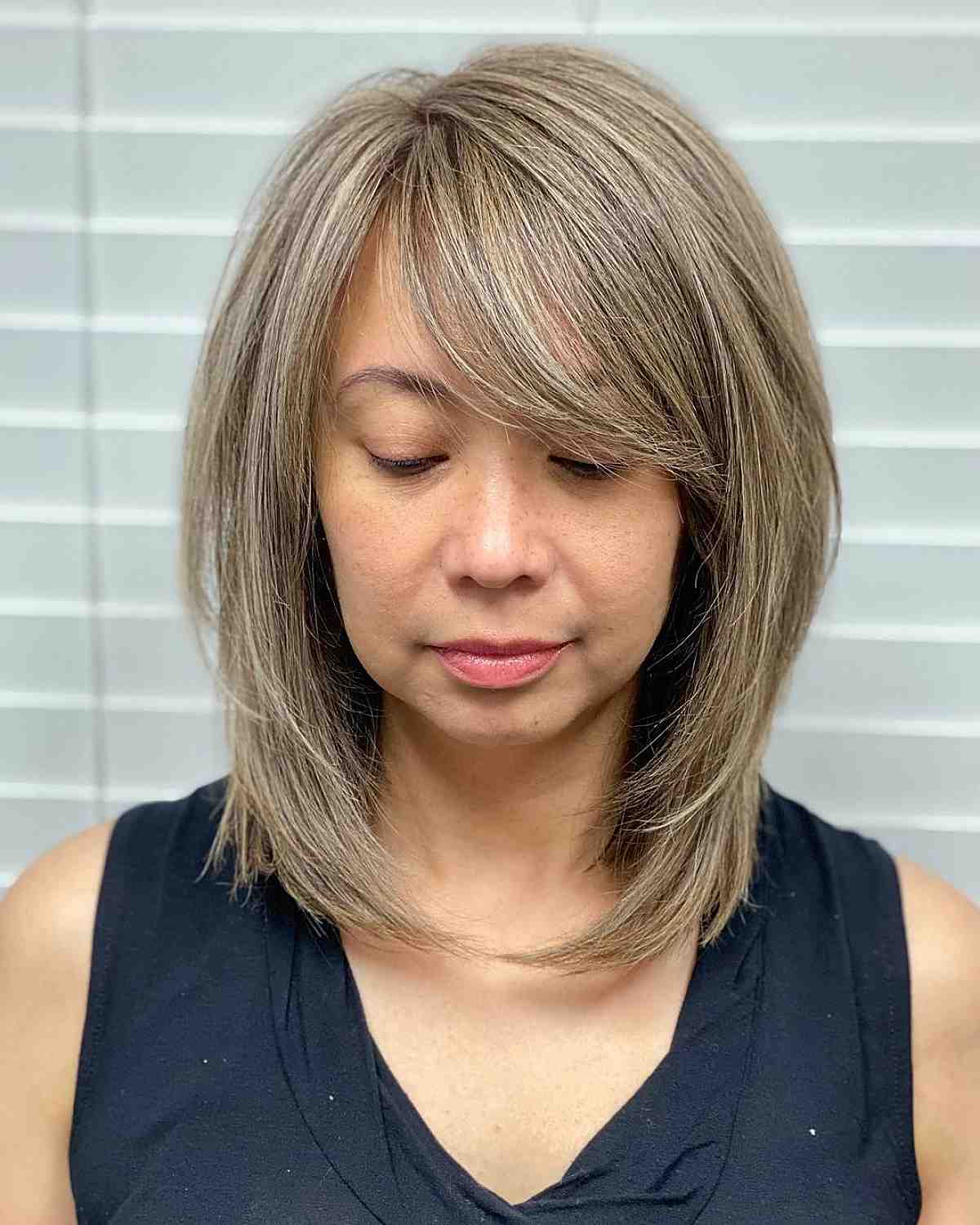 a lob with side bangs for ladies with round faces 1